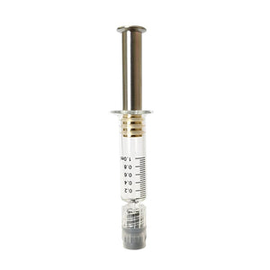 Patented air release distillate syringe featuring a silver colored metal plunger with gold plated tip inside a borosilicate glass syringe barrel with black graduation and gray luer lock tip