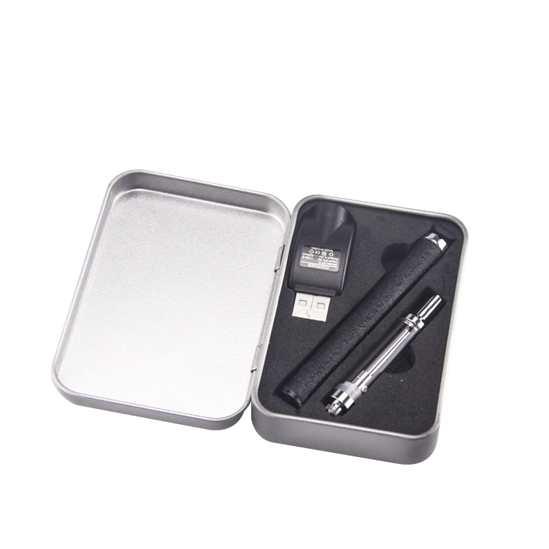 Embossed Black DMLift 510 threaded battery in silver metal case with a 510 thread vape cartridge and a usb charging attachment in foam slots molded for each item