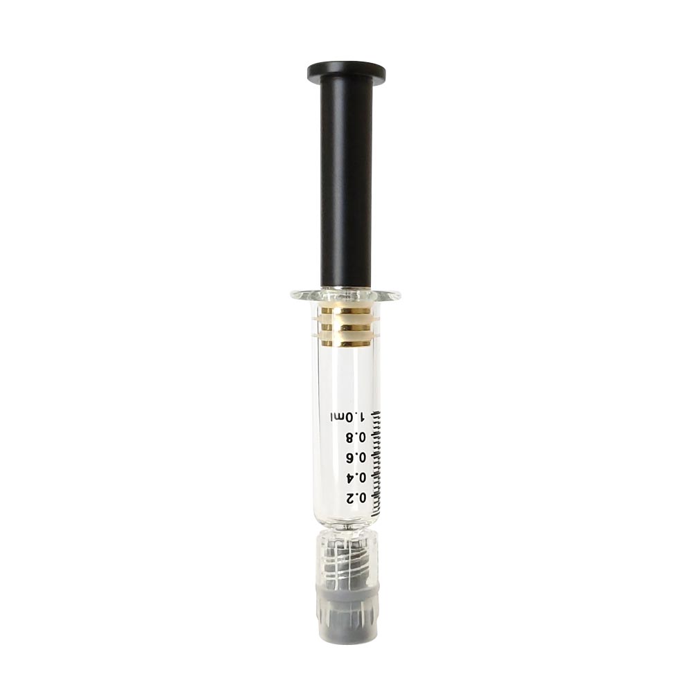 Patented air release distillate syringe featuring a silver colored metal plunger with gold plated tip inside a borosilicate glass syringe barrel with black graduation and gray luer lock tip
