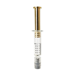 Gold colored metal plunger with gold plated tip inside a borosilicate glass syringe barrel with black graduation and gray luer lock tip